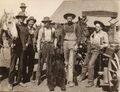 1915-rml-0233a-men-in-front-of-barn-with-bear-1600.jpg